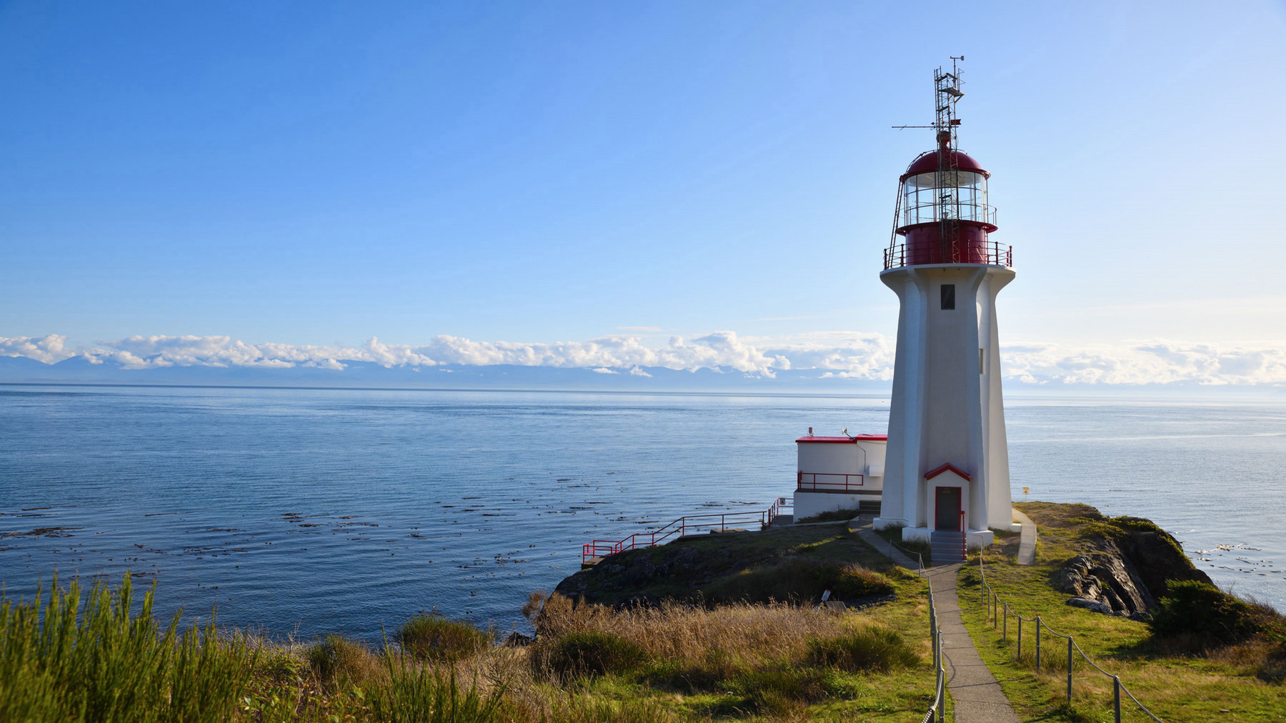 A lighthouse with the ocean in the background